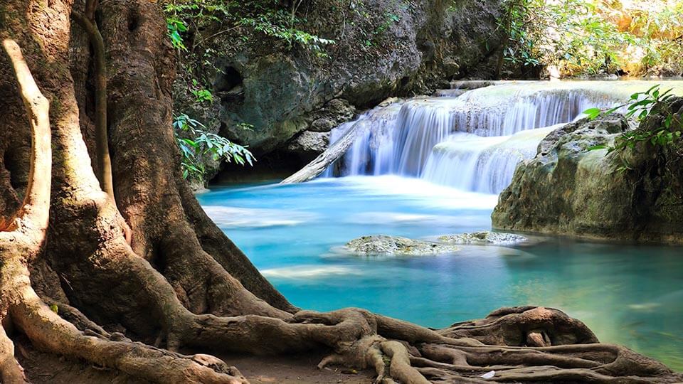 Erawan Waterfall in Erawan National Park, Thailand – turquoise pool, lush forest, and limestone rocks